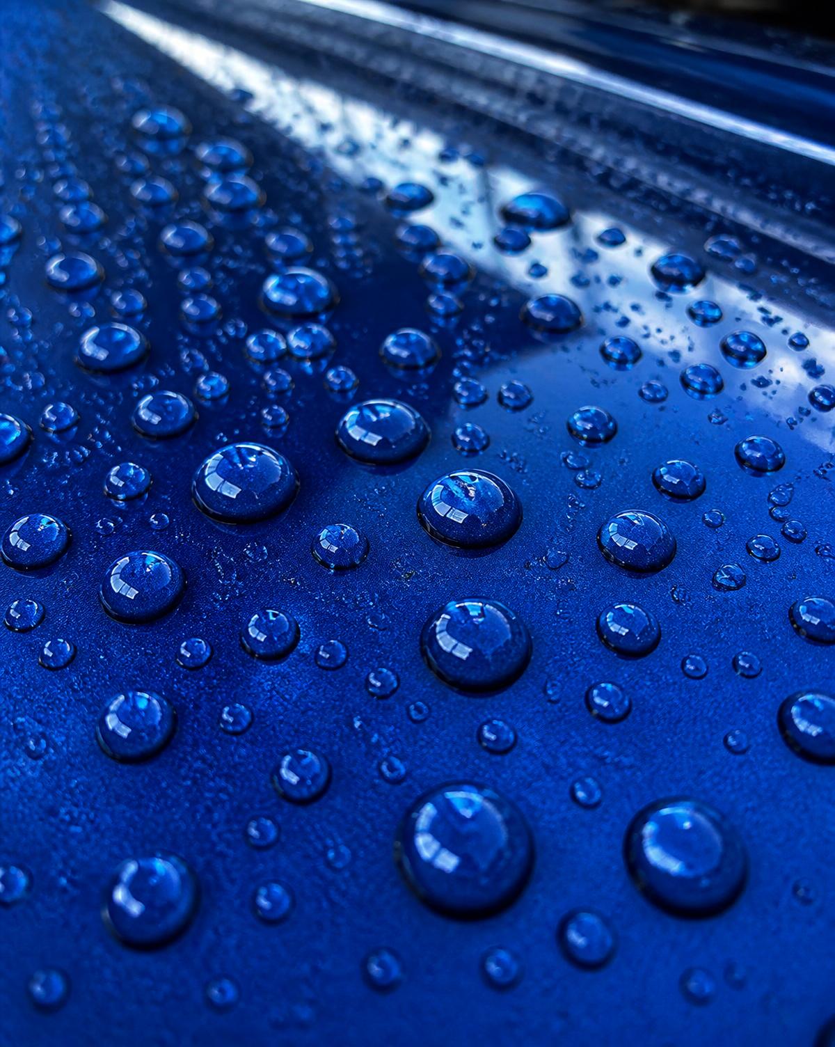 Water beading on freshly ceramic coated blue paint